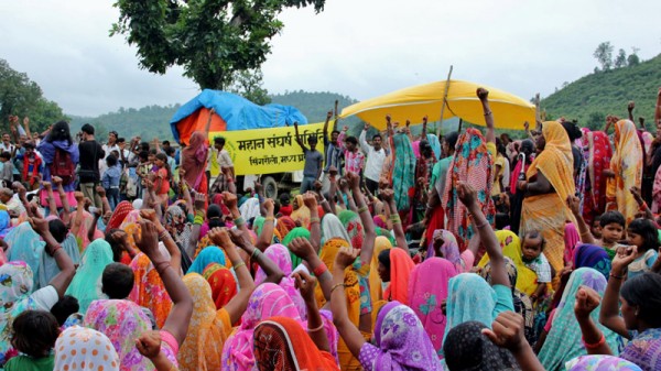 Tribal women from villages adjacent to Mahan forests in central India raise slogan against coal mining and displacement during Rakshabandhan festival. (Avik Roy)